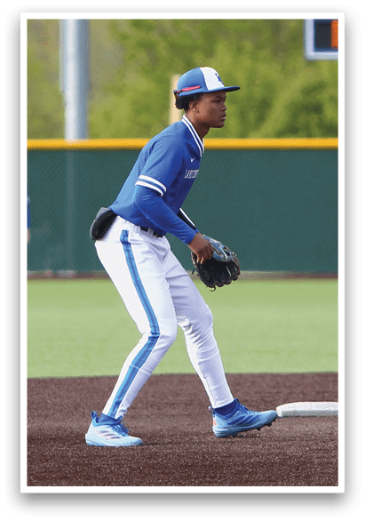 A baseball player in a blue and white uniform is running to a base. Description generated by AI