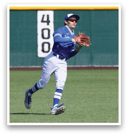 A baseball player wearing blue and white uniform is running on the field. Description generated by AI
