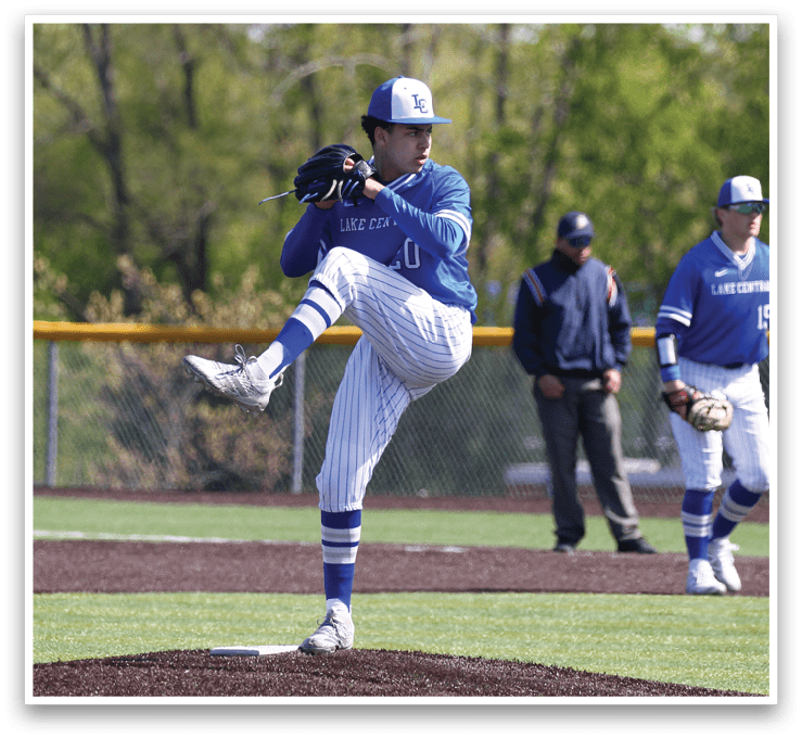 A baseball player in a blue uniform is pitching a ball. Description generated by AI
