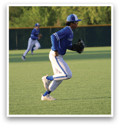 A baseball player in a blue and white uniform is sliding into a base. Description generated by AI