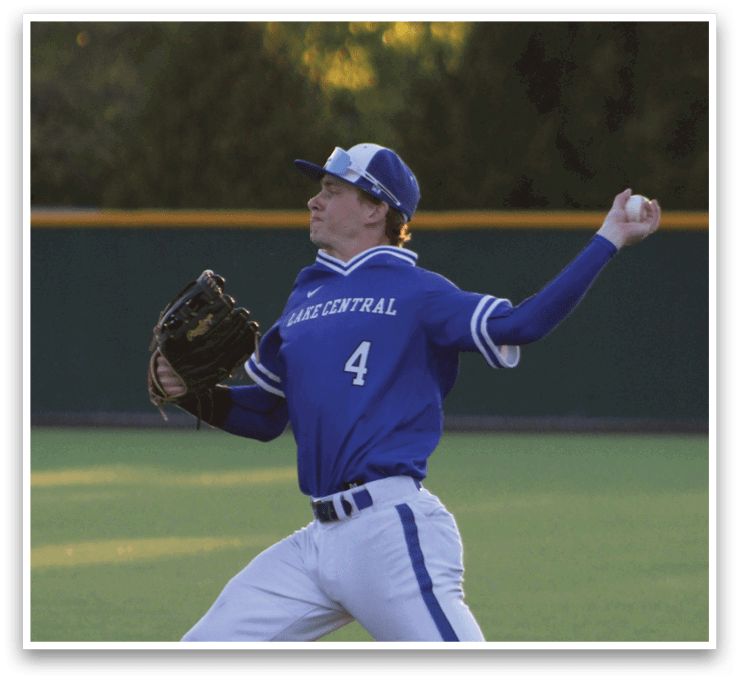 A baseball player in a blue uniform is throwing a ball. Description generated by AI