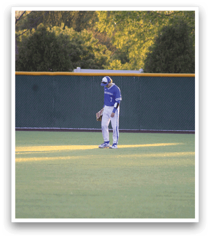 A baseball player standing on a field. Description generated by AI