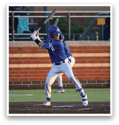 A baseball player in a blue uniform is swinging a bat. Description generated by AI