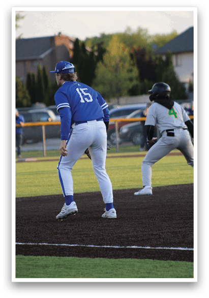 A baseball player wearing a blue and white uniform. Description generated by AI