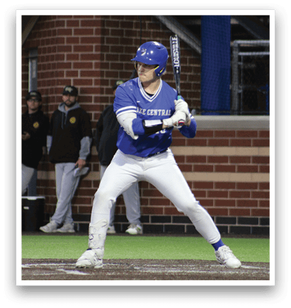 A baseball player in a blue and white uniform is swinging a bat. Description generated by AI