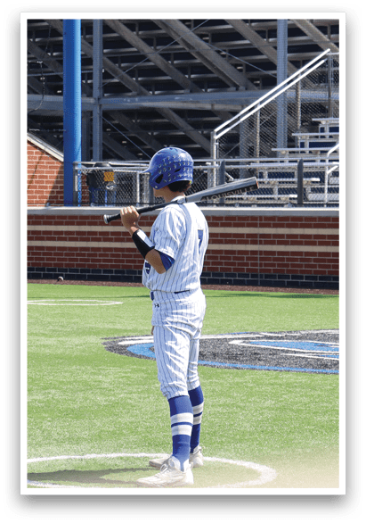 A baseball player is standing at home plate, holding a bat. Description generated by AI
