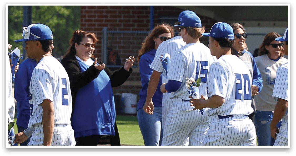 A group of people wearing baseball uniforms. Description generated by AI