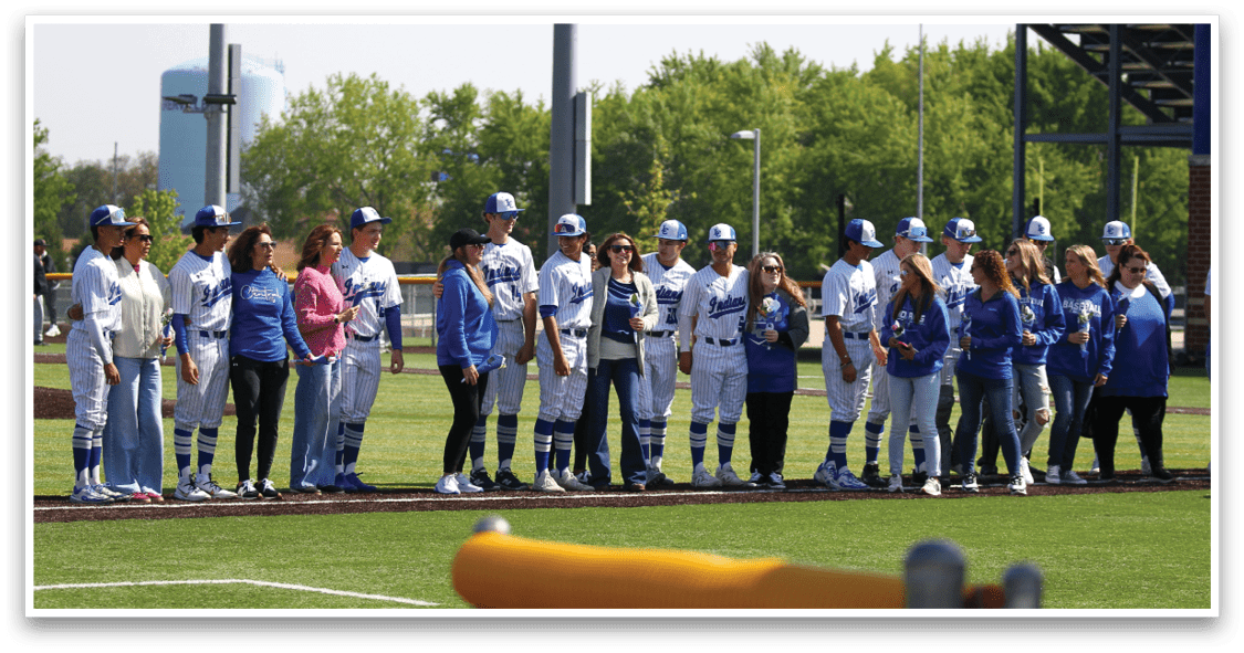 A group of people wearing blue and white uniforms. Description generated by AI