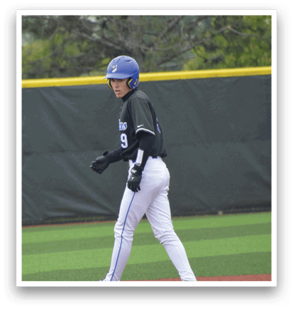 A baseball player wearing a blue helmet and white pants walks across the field. Description generated by AI