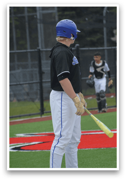 A baseball player holding a bat. Description generated by AI