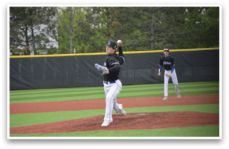 A baseball player in a black shirt and white pants is pitching a ball. Description generated by AI