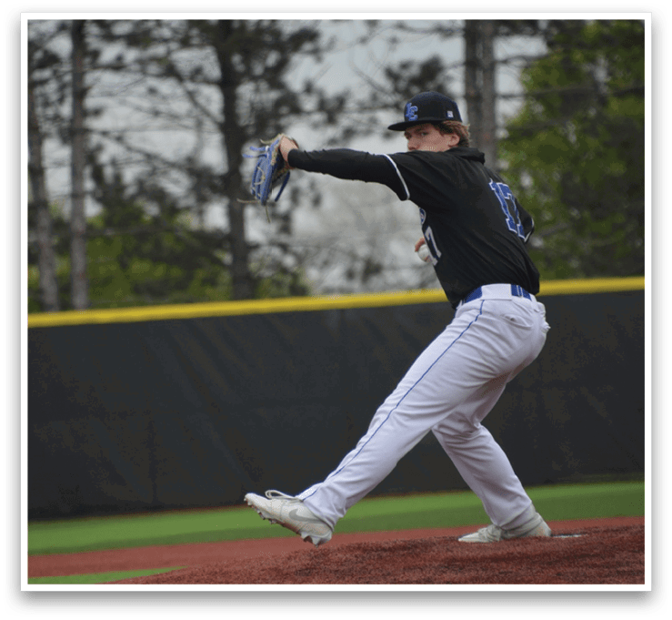 A baseball player in a black shirt and white pants is throwing a ball. Description generated by AI
