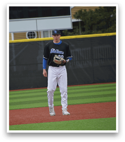 A baseball player wearing a black and blue shirt and white pants. Description generated by AI