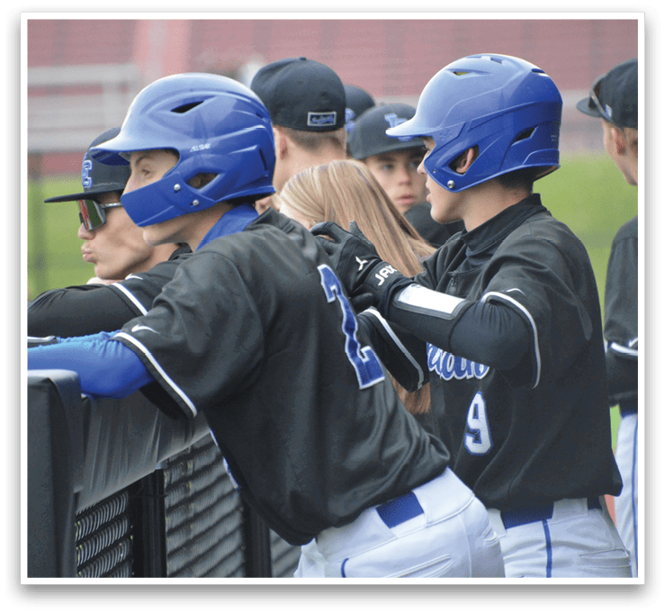 A group of baseball players wearing blue helmets and black shirts. Description generated by AI
