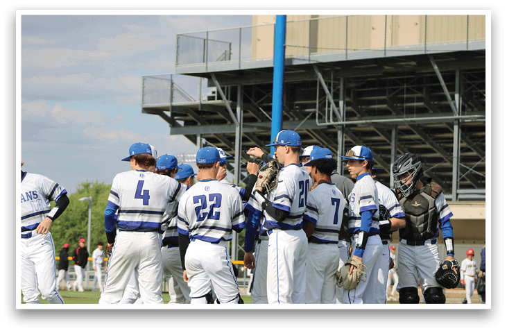 A group of baseball players wearing blue and white uniforms. Description generated by AI
