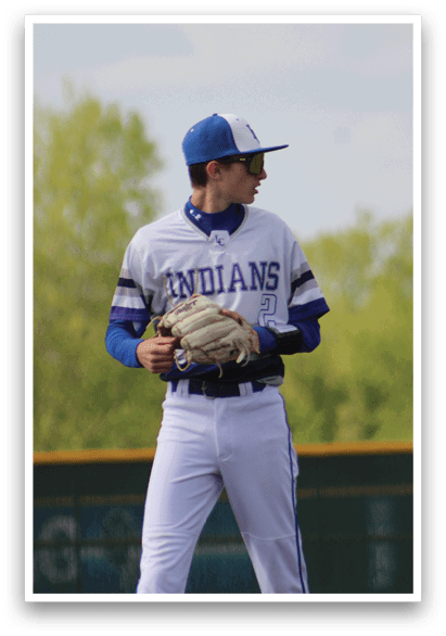 A baseball player wearing a blue and white uniform. Description generated by AI