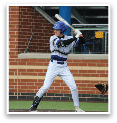 A baseball player in a blue and white uniform is holding a bat and preparing to swing. Description generated by AI