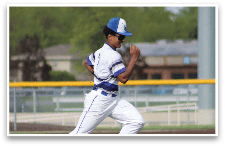 A baseball player in a white and blue uniform is running to catch a ball. Description generated by AI