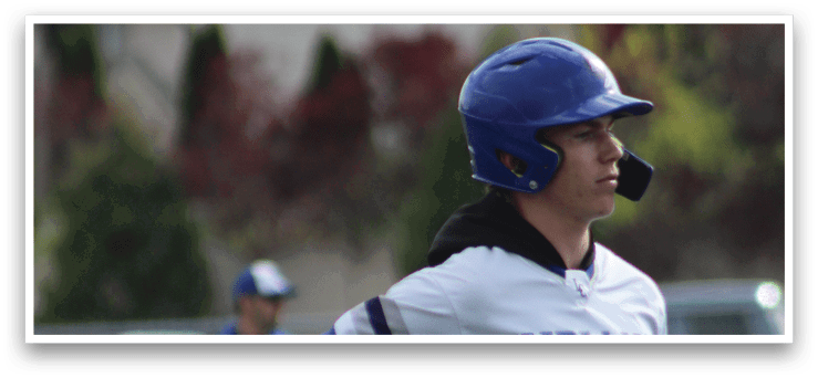 A baseball player wearing a blue helmet and white and blue uniform. Description generated by AI