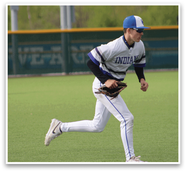 A baseball player in a white and blue uniform catching a ball. Description generated by AI