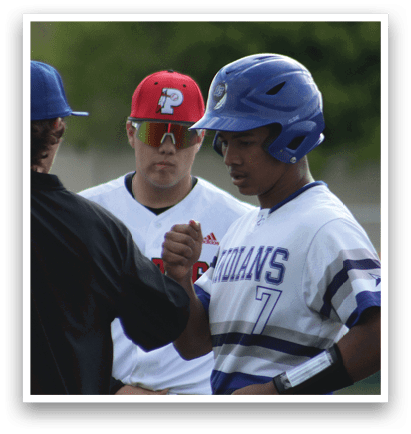 Two baseball players wearing blue and white uniforms. Description generated by AI