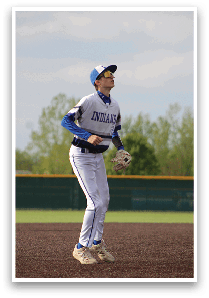 A baseball player wearing a blue and white uniform. Description generated by AI