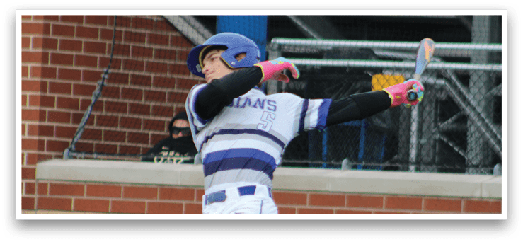 A baseball player in a blue and white uniform is jumping up to catch a ball. Description generated by AI