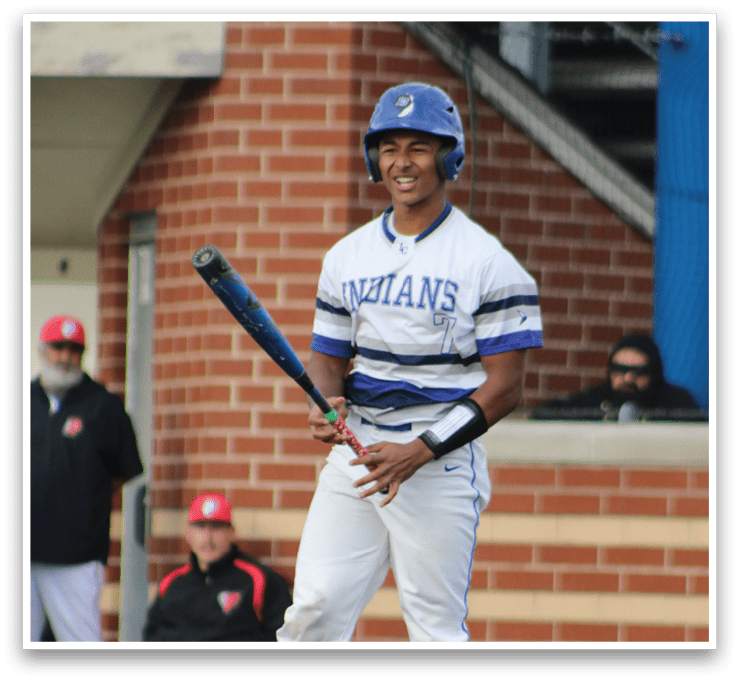 A baseball player holding a bat. Description generated by AI