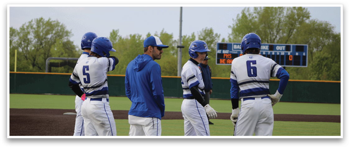 A group of baseball players standing on a field. Description generated by AI