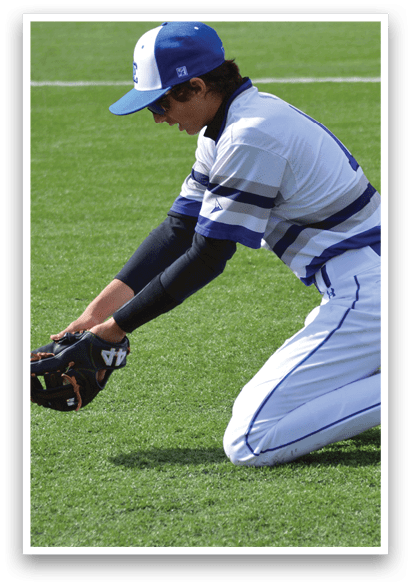 A baseball player kneeling on the ground with a catcher's mitt on his left hand. Description generated by AI