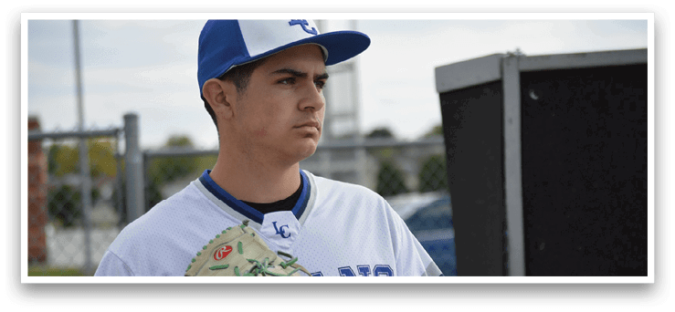 A baseball player wearing a blue and white uniform holding a catcher's mitt. Description generated by AI
