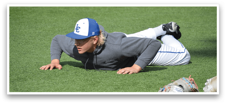 A man wearing a blue and white baseball cap is laying on the ground. Description generated by AI