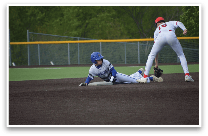 A baseball player slides into a base. Description generated by AI