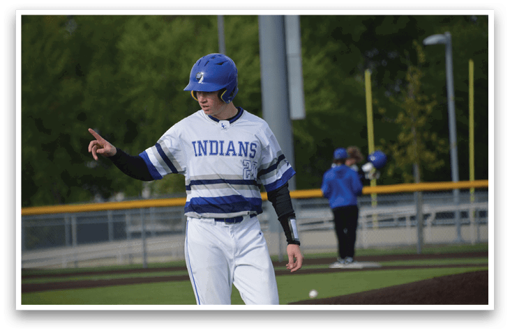 A baseball player wearing a blue and white uniform. Description generated by AI