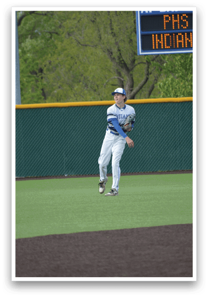 A baseball player wearing a blue and white uniform is standing on a baseball field. Description generated by AI