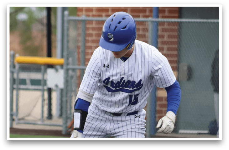 A baseball player in a blue and white uniform holding a bat. Description generated by AI