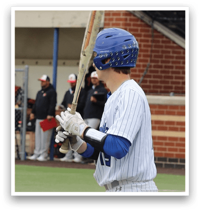 A baseball player holding a bat. Description generated by AI