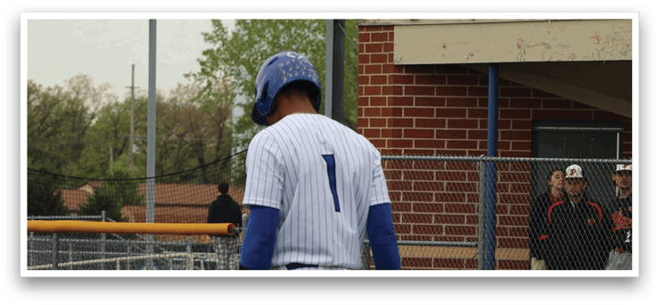 A baseball player wearing a blue and white uniform with the number 7 on the back. Description generated by AI