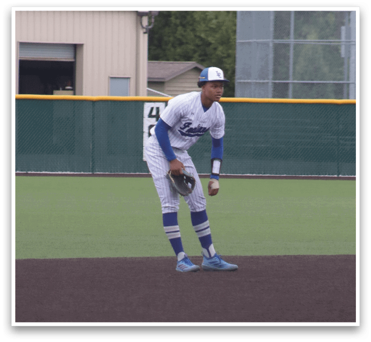 A baseball player wearing a blue and white uniform. Description generated by AI