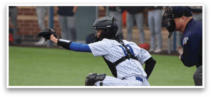 A baseball player is kneeling on the ground with his glove on. Description generated by AI
