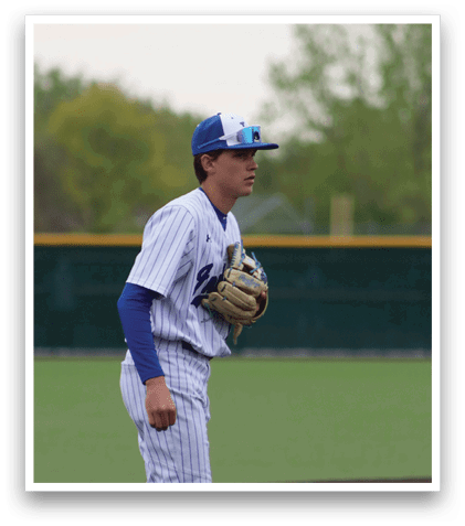 A baseball player wearing a blue and white uniform. Description generated by AI