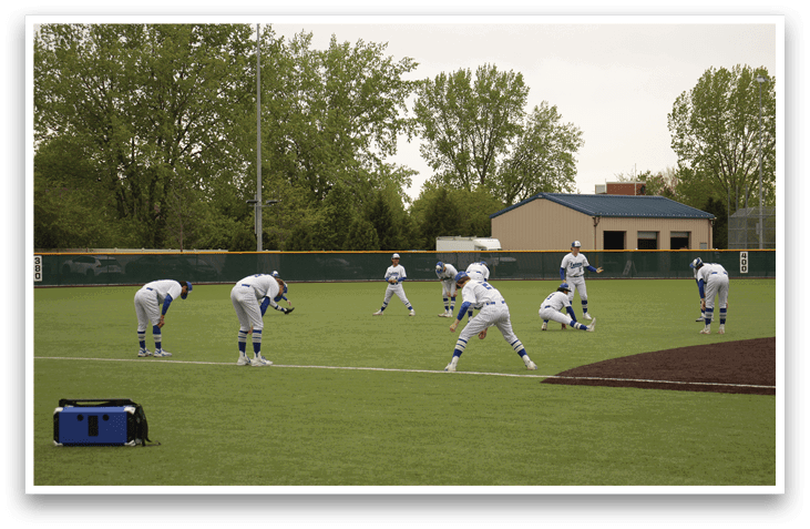 A group of baseball players are on a field. Description generated by AI