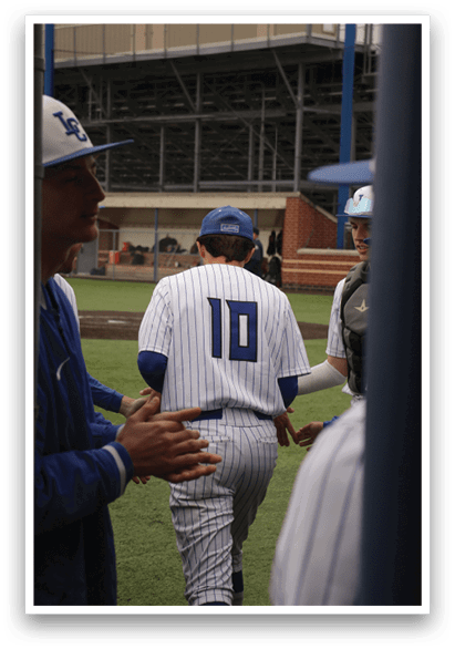 A baseball player wearing a blue and white uniform with the number 10 on the back. Description generated by AI