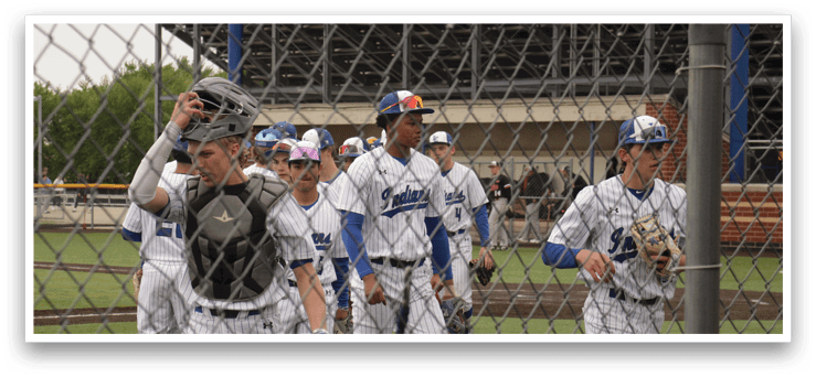 Baseball players walking on a field. Description generated by AI