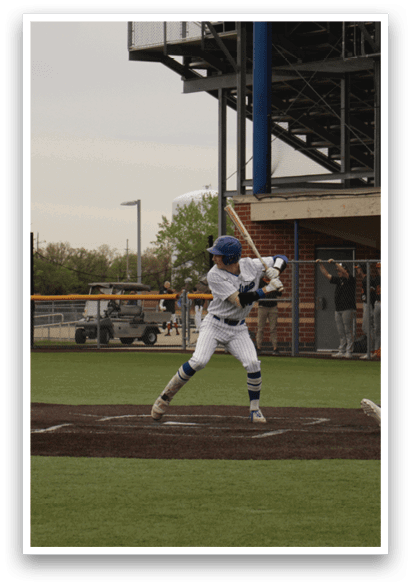 A baseball player is swinging a bat at a ball. Description generated by AI