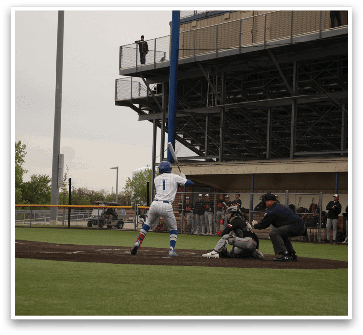 A baseball player is at bat, wearing a blue helmet. Description generated by AI