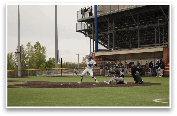 A baseball player is swinging a bat at a ball. Description generated by AI