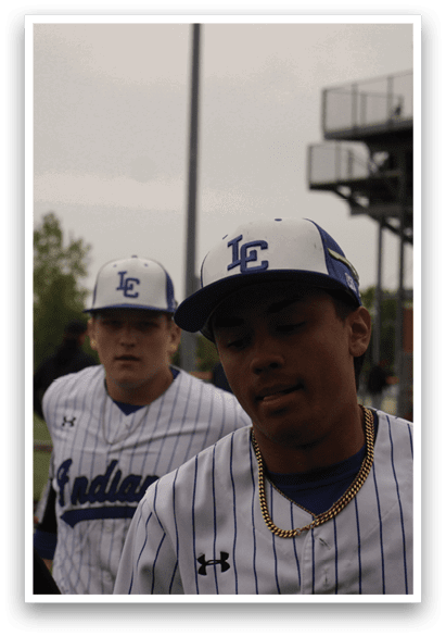 A group of baseball players wearing blue and white uniforms. Description generated by AI