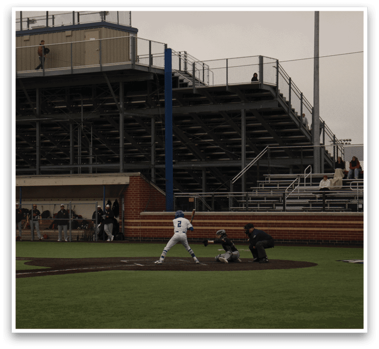 A baseball game is taking place on a field. Description generated by AI