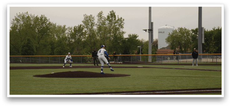 A baseball player is pitching a ball on a field. Description generated by AI